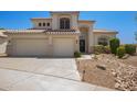 Charming front exterior featuring a three car garage, desert landscaping, and lovely architectural details at 1953 W Lark Dr, Chandler, AZ 85286