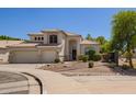 Attractive front exterior showcases desert landscaping, a three-car garage, and timeless architecture at 1953 W Lark Dr, Chandler, AZ 85286