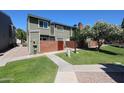 A two-story townhome with manicured lawn and landscaping at 2301 E University Dr # 210, Mesa, AZ 85213