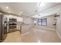 A kitchen with stainless steel appliances and granite countertops opens to a living room at 2301 E University Dr # 210, Mesa, AZ 85213