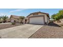 A single-story desert home featuring a terracotta roof and gravel landscaping at 23075 W Arrow Dr, Buckeye, AZ 85326