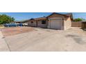 View of the exterior with a concrete driveway and a partial desert landscape at 233 E 7Th Dr, Mesa, AZ 85210