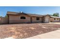 Charming single-story home featuring an attached garage and low maintenance front yard at 233 E 7Th Dr, Mesa, AZ 85210