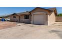 Single-story home featuring an attached garage and a low maintenance front yard at 233 E 7Th Dr, Mesa, AZ 85210