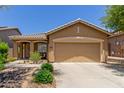 Charming single-story home featuring a well-manicured front yard and a two-car garage at 2458 W Warren Dr, Anthem, AZ 85086
