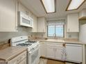 Bright kitchen with white cabinets, modern appliances, and a window overlooking the sink at 2701 E Allred Ave # 171, Mesa, AZ 85204