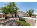 Single-story home featuring a two-car garage and desert landscaping at 3112 N 303Rd Dr, Buckeye, AZ 85396