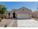 Single-story home featuring a two-car garage and low maintenance desert landscaping at 3112 N 303Rd Dr, Buckeye, AZ 85396