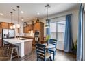 Bright kitchen boasts stainless steel appliances, center island, and adjacent dining area at 31332 N 137Th Ln, Peoria, AZ 85383