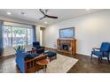 Inviting living room featuring a cozy fireplace, plush seating, and stylish decor at 31332 N 137Th Ln, Peoria, AZ 85383