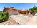 Inviting single-story home featuring a two-car garage and low maintenance desert landscaping at 36538 W La Paz St, Maricopa, AZ 85138