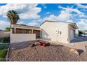 Home featuring desert landscaping, white siding and an attached two car garage at 4016 W Royal Palm Rd, Phoenix, AZ 85051