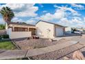 Exterior of home showcasing desert landscaping, white siding and an attached two car garage at 4016 W Royal Palm Rd, Phoenix, AZ 85051