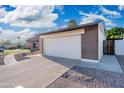 Home featuring a two-car garage, desert landscaping and brick accents on a sunny day at 4016 W Royal Palm Rd, Phoenix, AZ 85051