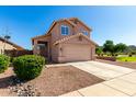 Charming two-story home with desert landscaping and a two-car garage at 4031 W Lone Cactus Dr, Glendale, AZ 85308