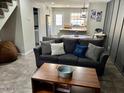Open-concept living room and kitchen boasts lots of space, tile flooring, and a relaxed atmosphere at 4601 N 102Nd Ave # 1052, Phoenix, AZ 85037