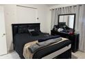 This bedroom features an all-black comforter set and a dresser with a mirror for prepping for your day or night out at 4601 N 102Nd Ave # 1194, Phoenix, AZ 85037