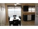 Eat-in kitchen featuring modern appliances, dark cabinetry and bright natural light at 4767 W Wahalla Ln, Glendale, AZ 85308