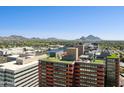 Expansive city view with mountains, golf course, and modern buildings in the distance at 4808 N 24Th St # 1228, Phoenix, AZ 85016