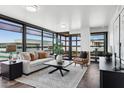 Bright living room featuring floor to ceiling windows and elegant contemporary furnishings at 4808 N 24Th St # 1228, Phoenix, AZ 85016
