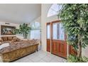 Bright entryway featuring tile floors, a wood door, and a large arched window providing plenty of natural light at 4928 E Paradise Ln, Scottsdale, AZ 85254