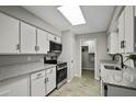 Modern kitchen featuring white cabinets, granite countertops, and stainless steel appliances at 5148 E Edgewood Cir, Mesa, AZ 85206