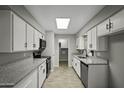 Bright kitchen with white cabinets, granite countertops, stainless steel appliances, and wood-look flooring at 5148 E Edgewood Cir, Mesa, AZ 85206