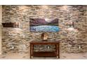 Inviting entryway with stone accent wall, console table, and stylish decor at 5607 W Alyssa Ln, Phoenix, AZ 85083