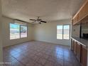 Spacious living room filled with natural light, tile flooring, and a ceiling fan at 5634 W Puget Ave, Glendale, AZ 85302