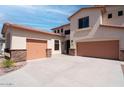 Home exterior showcasing a spacious driveway leading to a two-car garage and a one-car garage at 6014 W Oberlin Way, Phoenix, AZ 85083