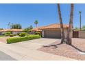 Charming home featuring a tile roof, manicured landscaping, and a spacious driveway at 6017 E Kathleen Rd, Scottsdale, AZ 85254