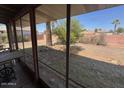 View of a large backyard enclosed by a red brick fence as seen from a covered patio at 6231 N 25Th Ave, Phoenix, AZ 85015