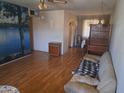 The living room features wood laminate flooring and a decorative lake mural at 6231 N 25Th Ave, Phoenix, AZ 85015