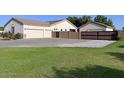 View of a well-maintained home with a large garage and mature landscaping at 661 W Via De Palmas --, San Tan Valley, AZ 85140