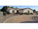 Charming single-story home featuring well-maintained landscaping and a welcoming entrance at 661 W Via De Palmas --, San Tan Valley, AZ 85140