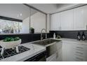 Kitchen featuring modern stainless-steel appliances, granite countertops, and sleek cabinetry at 753 W 6Th Dr, Mesa, AZ 85210