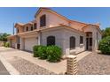 A charming home with a tile roof, a well-kept lawn, and an attached two-car garage at 7621 S Bonarden Ln, Tempe, AZ 85284