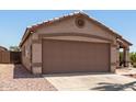 A two-car garage with a concrete driveway and low-maintenance desert landscaping at 8609 W Eva St, Peoria, AZ 85345