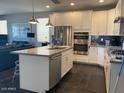 Modern kitchen with stainless steel appliances, granite countertops, and white cabinetry at 9141 W Dreyfus Dr, Peoria, AZ 85381