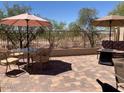 Paver patio with multiple seating areas and views of the surrounding desert landscape at 9141 W Dreyfus Dr, Peoria, AZ 85381