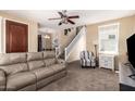 Inviting living room with a staircase, comfortable seating, and natural light, creating a warm atmosphere at 10062 E Isleta Ave, Mesa, AZ 85209