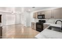 Modern kitchen with stainless steel appliances, white countertops, and tile floors at 10429 W Miami St, Tolleson, AZ 85353