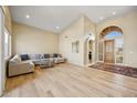 Bright living room features a soaring ceiling, blonde wood flooring and modern furniture at 11816 E Terra Dr, Scottsdale, AZ 85259