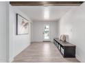 Inviting entryway with wood-look tile floors, bench seating and modern art at 13012 N 36Th Dr, Phoenix, AZ 85029
