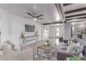 Open-concept living room with ceiling fan, stylish decor, and wood-look flooring at 13012 N 36Th Dr, Phoenix, AZ 85029