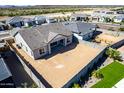Aerial view of a home's backyard featuring a patio and plenty of dirt ready for new landscaping at 13619 W Hackamore Dr, Peoria, AZ 85383