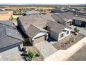 Aerial view of a charming house with a well-manicured front yard, lush lawn and neutral color palette at 13619 W Hackamore Dr, Peoria, AZ 85383