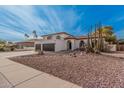 Beautiful property showcasing desert landscaping, a private balcony, and a spacious three-car garage at 15806 N 45Th Pl, Phoenix, AZ 85032