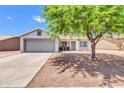 Inviting single-story home featuring a two-car garage, desert landscaping, and a well-maintained front yard at 1858 S Ocotillo Dr, Apache Junction, AZ 85120