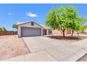 Cozy single-story home with a two-car garage, easy-care landscaping, and a bright, sunny facade at 1858 S Ocotillo Dr, Apache Junction, AZ 85120